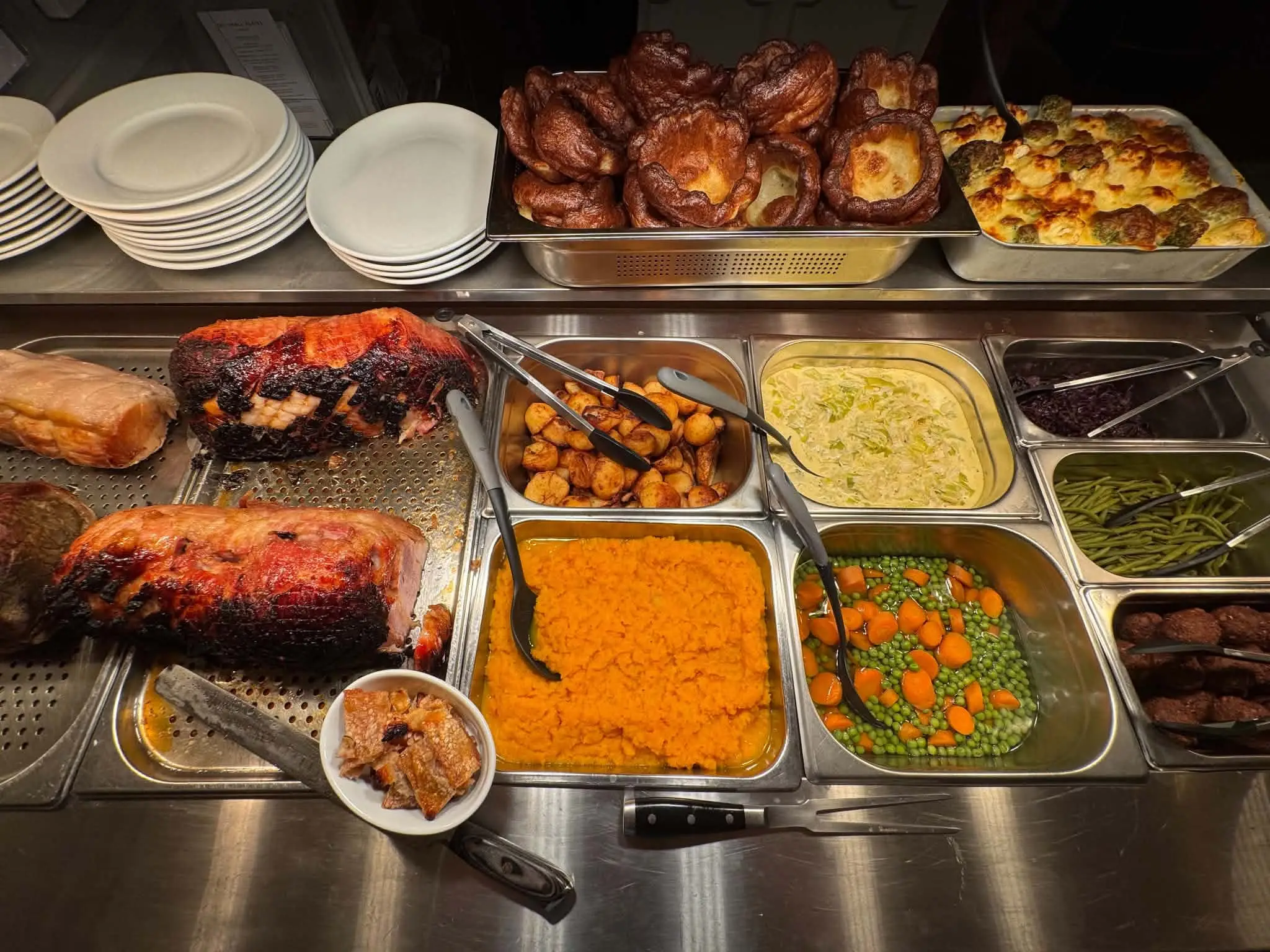 The Sunday carvery servery at The Tavern Inn: roast meats, roast potatoes, Yorkshire puddings, cauliflower cheese, red cabbage, green beans, peas and carrots