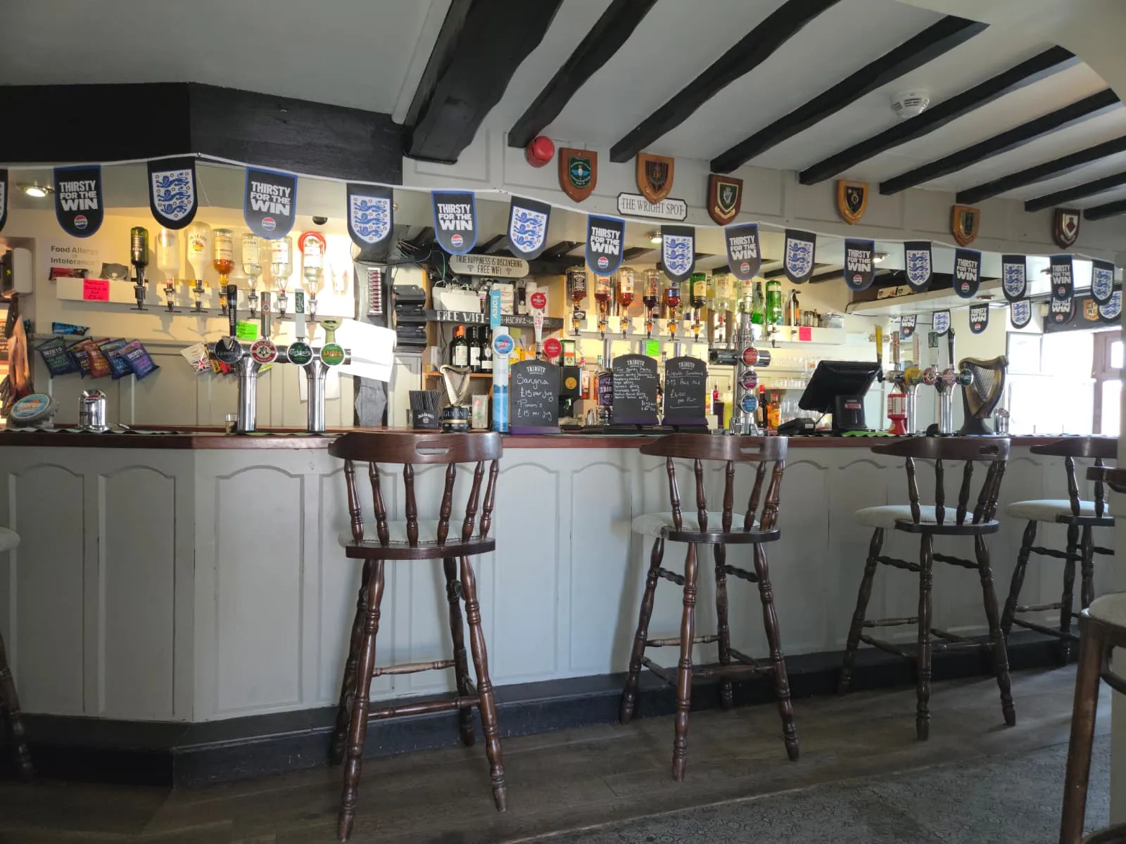 The beamed bar at The Tavern Inn, Newquay, with hand-pulled ales and bar stools